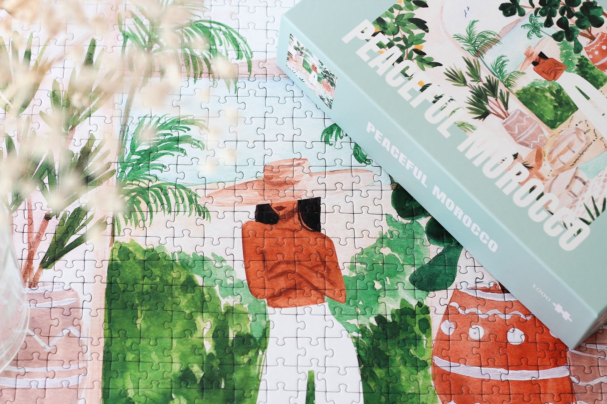 Außergewöhnliches Puzzle für Erwachsene mit einer Illustration von einer Frau in Marokko umgeben von Meer, tropischen Pflanzen und Zitronen.