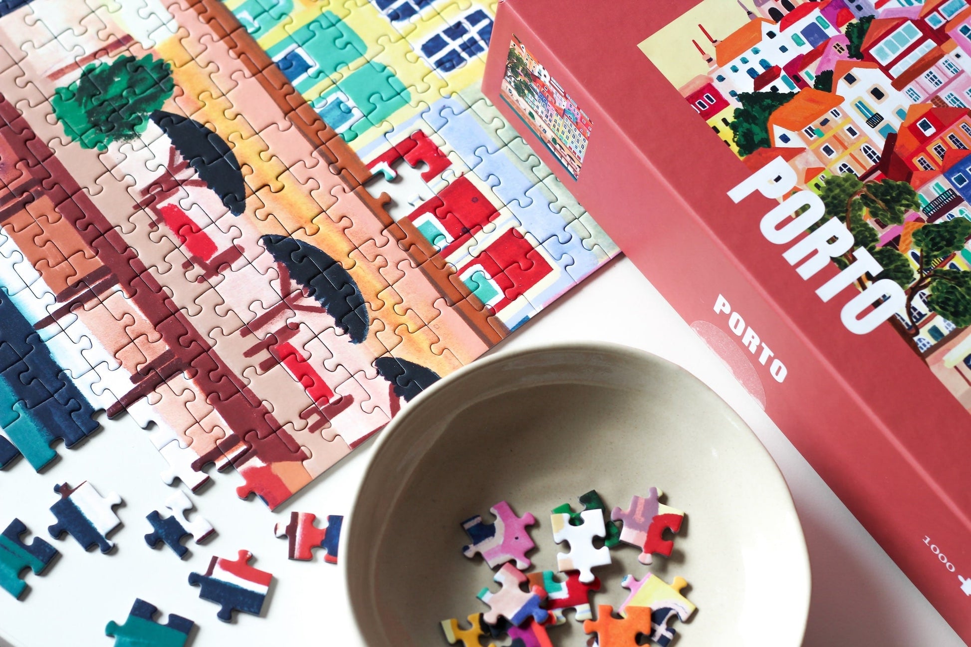 1000-teiliges Puzzle für Erwachsene, dass die bunten Häuser Portos am Wasser zeigt.