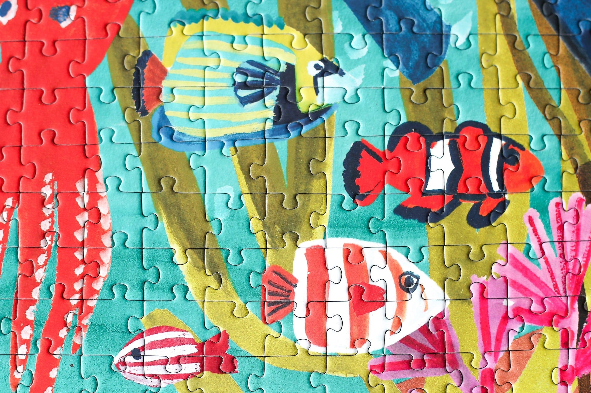 10000-teiliges, nachhaltiges Puzzle für Erwachsene, das eine farbenfrohe Unterwasserlandschaft mit Taucherinnen, Fischen, einem Hai, einer Schildkröte, einem Oktopus und einem Rochen zeigt.